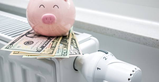 A happy piggy bank showing the money saved by using an energy efficient heater.