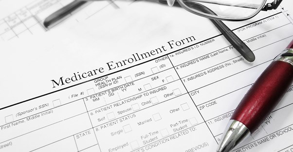 Glasses and a pen on a medicare enrollment form
