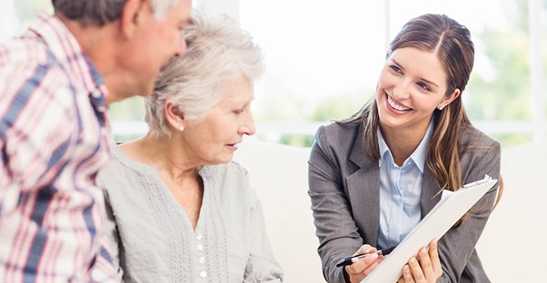 woman going over senior living options with elderly couple