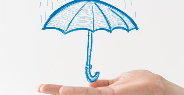 a man presenting a sketch of an umbrella to illustrate how the types of liability insurance protect comapnies