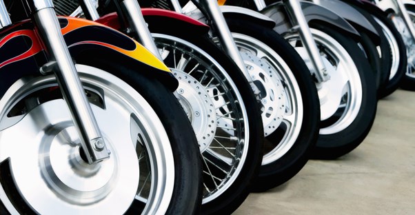 Motorcycles lined up in a row waiting to be evaluated by an insurer
