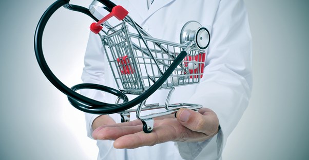 A doctor holding an image of a stethoscope in a shopping cart to represent shopping for health insurance that includes five necessary services.