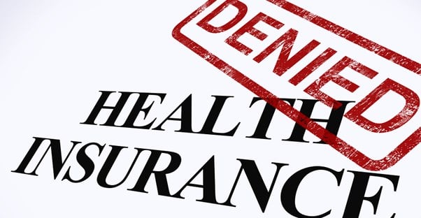 A red denied stamp over the words Health Insurance