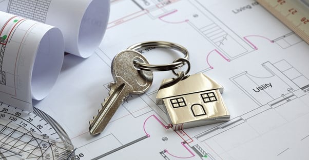 Key laying on a layout of an insured rental property