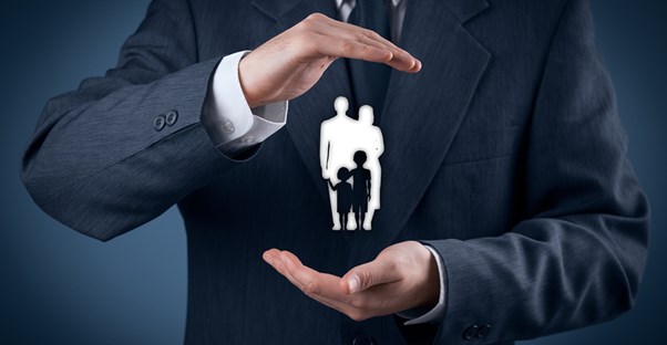 Man holding a representation of a family affected by unclaimed life insurance