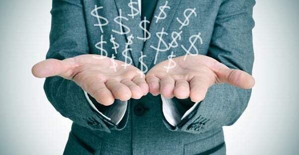 Man holding dollar signs in his hand that represent the peer to peer lending process