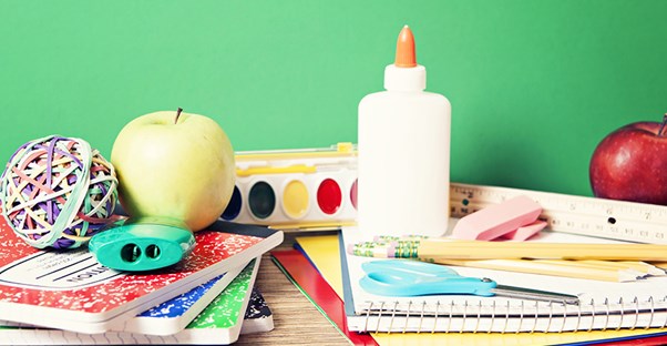 an apple, school supplies, and arts and craft materials signify a charter school