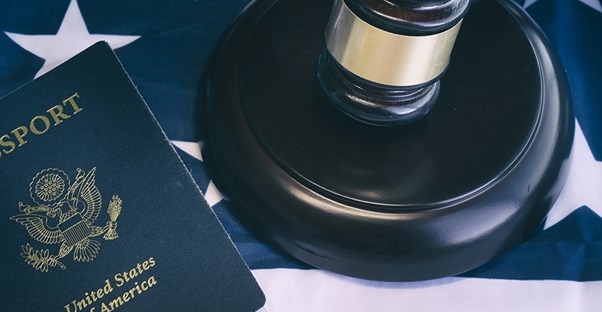 An american flag next to a passport and gavel