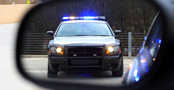 cop car in rearview mirror