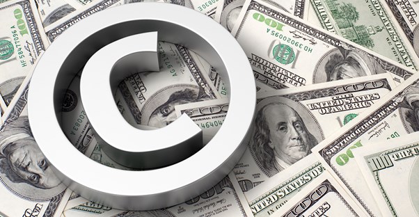 3D copyright symbol on top of $100 bills