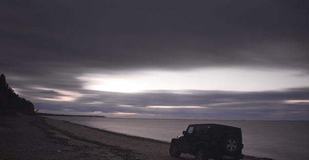 A Jeep SUV driving on beach