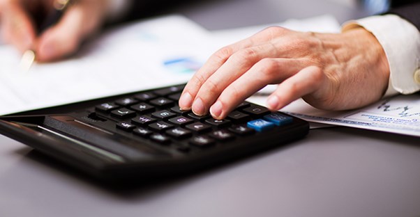 person calculating tax debt relief