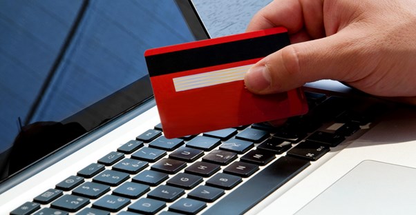 Person using a charge card for online shopping