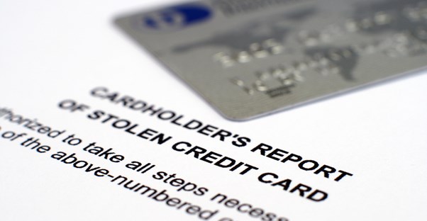Close up image of a credit card and a cardholder's report of stolen credit card to demonstrate the danger of credit card processing.
