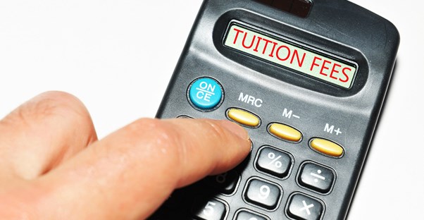 A calculator screen reading TUITION FEES as a student calculates how to pay for college through scholarships.