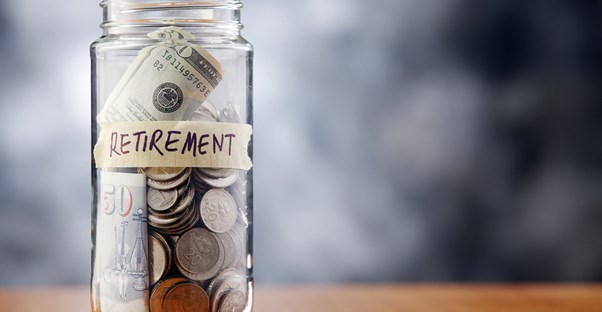 A jar labeled RETIREMENT holding spare change  to represent a reason you need a financial adviser.