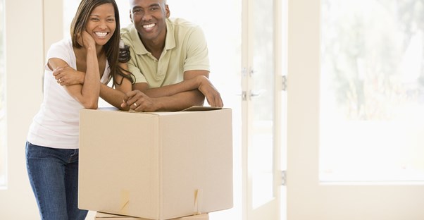 First Time Home Buyers Leaning on Boxes