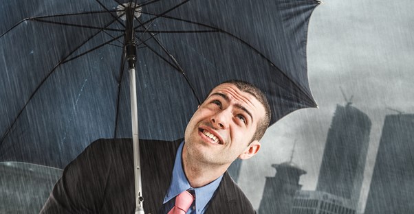 Man holding umbrella in rainstorm