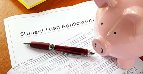 Piggy Bank filling out a student loan application