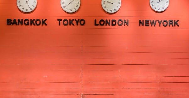 Four time zone clocks on a wall
