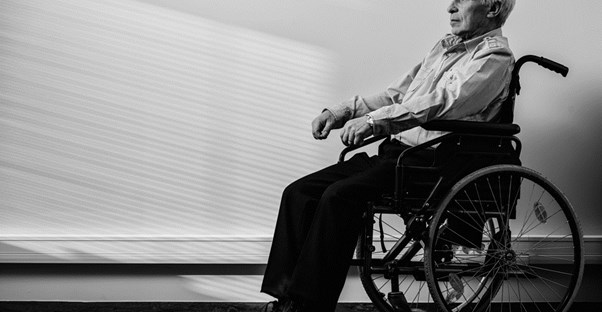 elderly man sits in a wheelchair