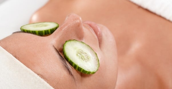 A woman relaxes with cucumbers on her eyelids