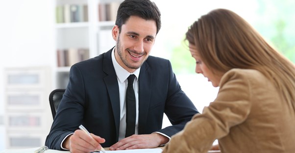 A financial advisor goes over paperwork with a potential client