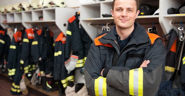 Firefighter stops for a picture in the locker room