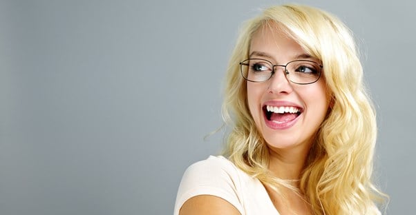 Girl with glasses laughs