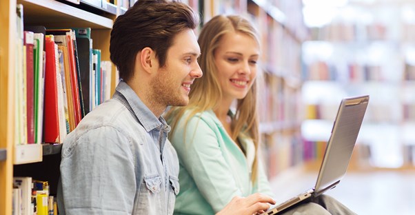 Two students shop for textbooks online