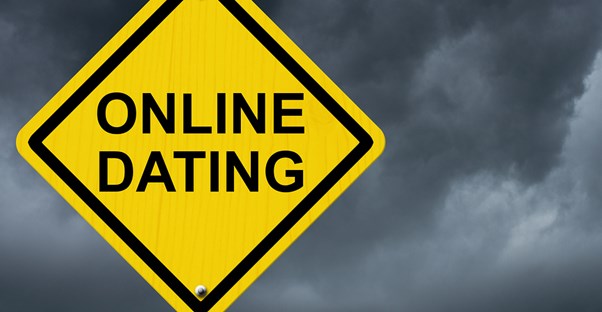 a warning street sign that says online dating