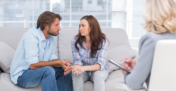 A marriage counselor discussing what to expect during couple's therapy with potential clients.