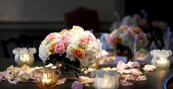 Flowers serve as a centerpiece on a table with candles