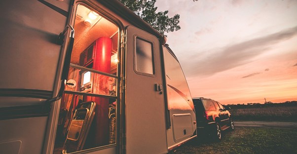 An SUV pulls a camper along on a retirement adventure.