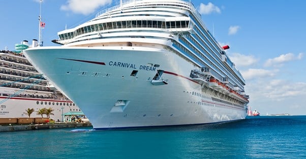 a large Carnival cruise liner docked in port