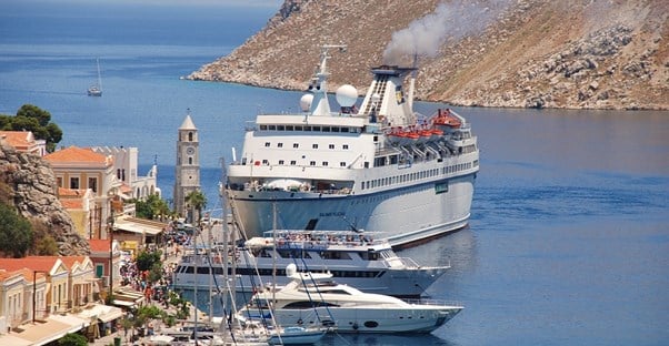 a greek cruise ship pulls up to port