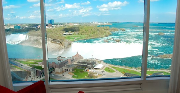 a view from inside a hotel room overlooking horseshoe falls in niagara falls