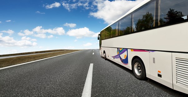 a tour bus barrels down the highway to its next destination