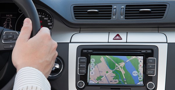 a driver views an in-car GPS system