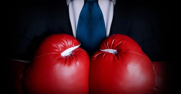 A suit with red boxing gloves