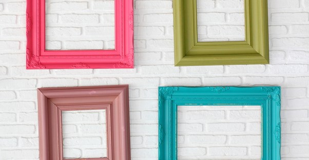 Empy picture frames hang on a wall