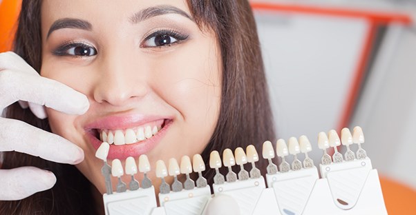 A woman tries cosmetic dental implants