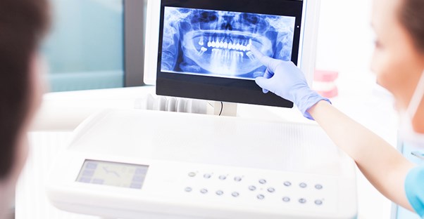 Dentists examine a dental X-ray