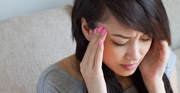 A woman experiences a stress headache