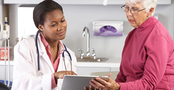 a doctor and patient reviewing an electronic medical record