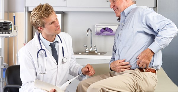 a doctor explaining hip replacement costs