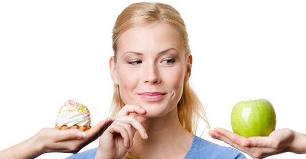 a woman choosing between two snacks