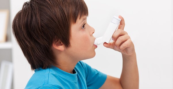 a boy using an inhaler