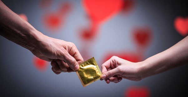 a couple holding a condom
