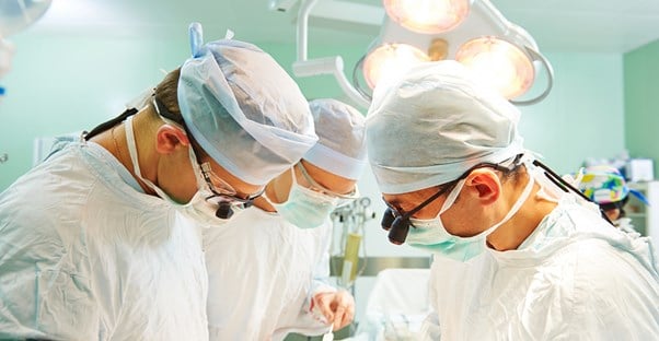 surgeons installing an implantable cardioverter defibrillator